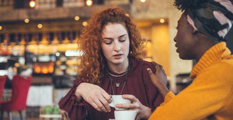 two women talking over coffee