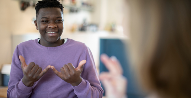 A young person using sign language.