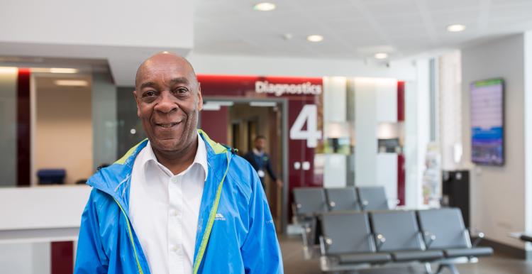 Man in hospital setting smiling directly at the camera