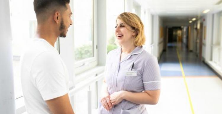 Young man talking to nurse in a hospital setting