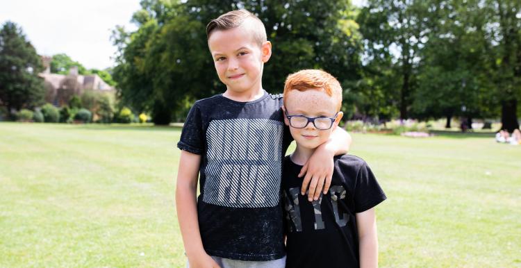 Two boys outside looking athe camera