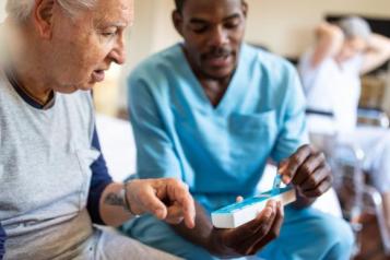 nurse sitting on bed giving instructions