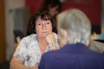 Woman sitting opposite someone in a conversation or meeting